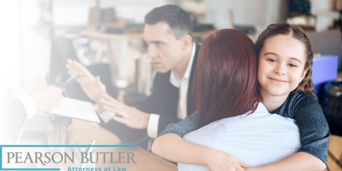 Daughter hugging mother while father talks in the background